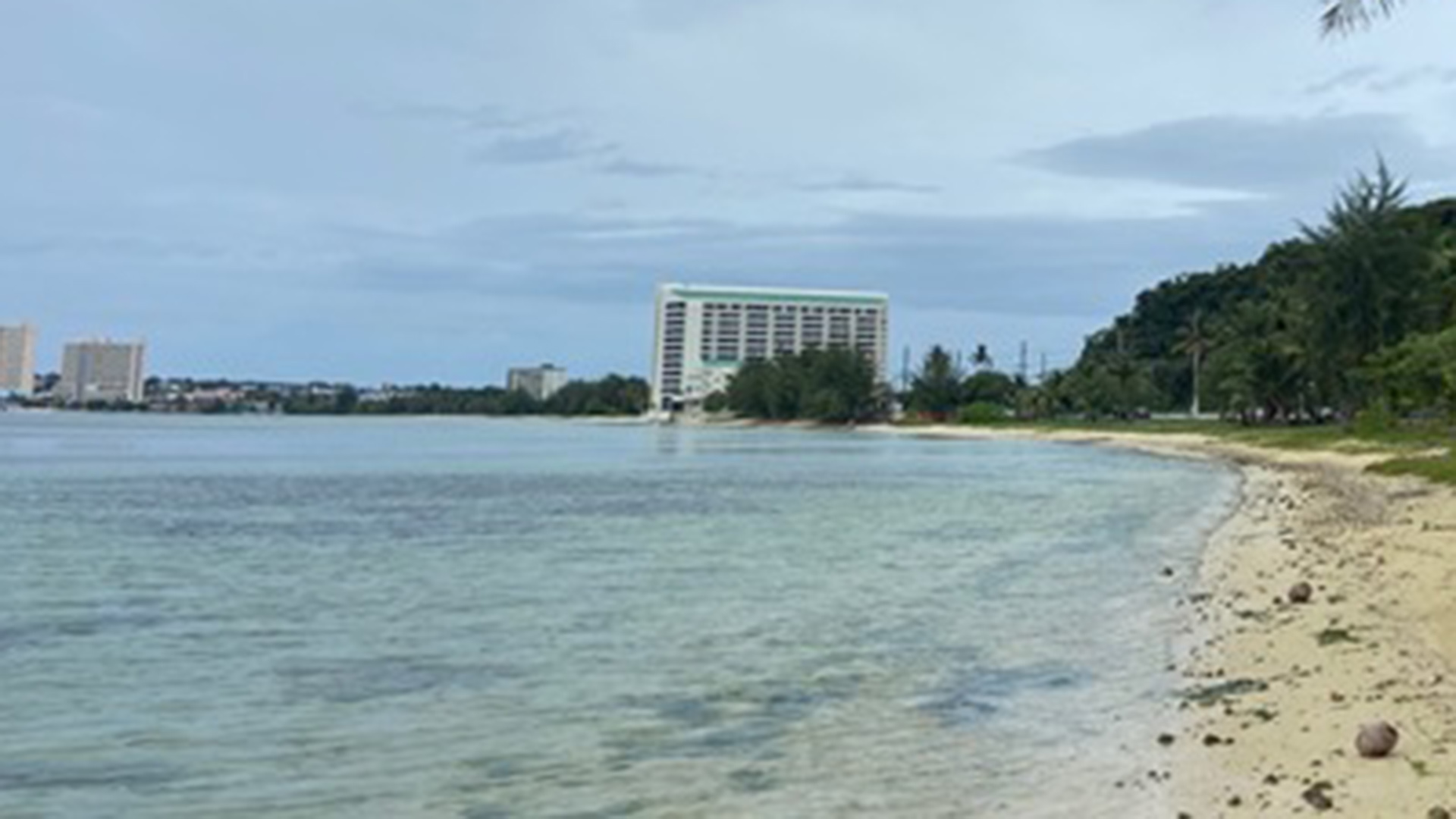 Taken by Lauren Moseley. Caption: Daily walks along Agana Bay Beach with our hotel in the background.