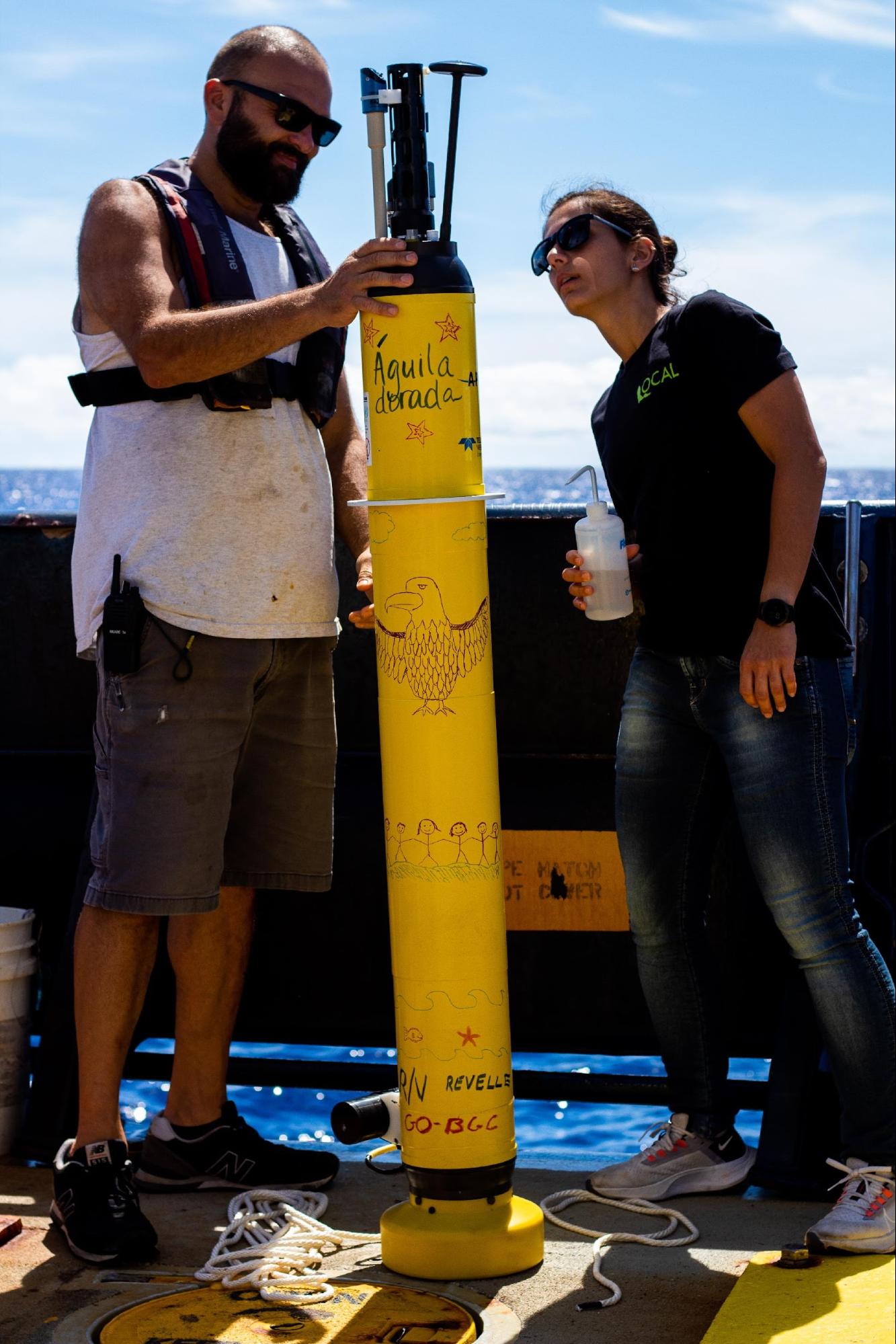 Rec-tech Josh Manger (left) and CTD watchstander Mariana Aguirre Nunes (right) cleaning the sensors before the float deployment. Photo Credit: Vic Dana