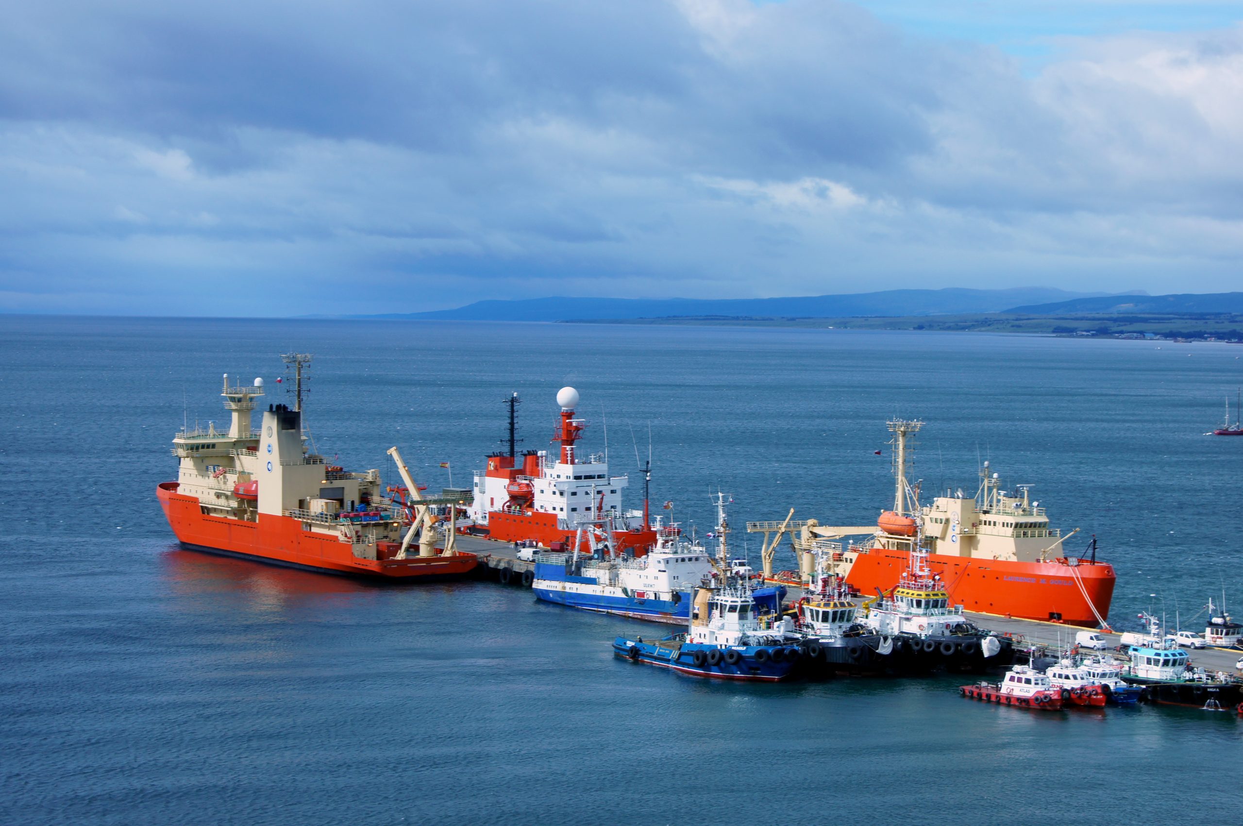 The U.S. Antarctic Program's two research vessels dock at the Prat Pier, Punta Arenas, Chile. At left is the Nathaniel B. Palmer. At right is the Laurence M. Gould. The red and white ship in between the two U.S. vessels is a Chilean research vessel. Punta Arenas is the point of departure for the majority of U.S. research in the Antarctic Peninsula area.