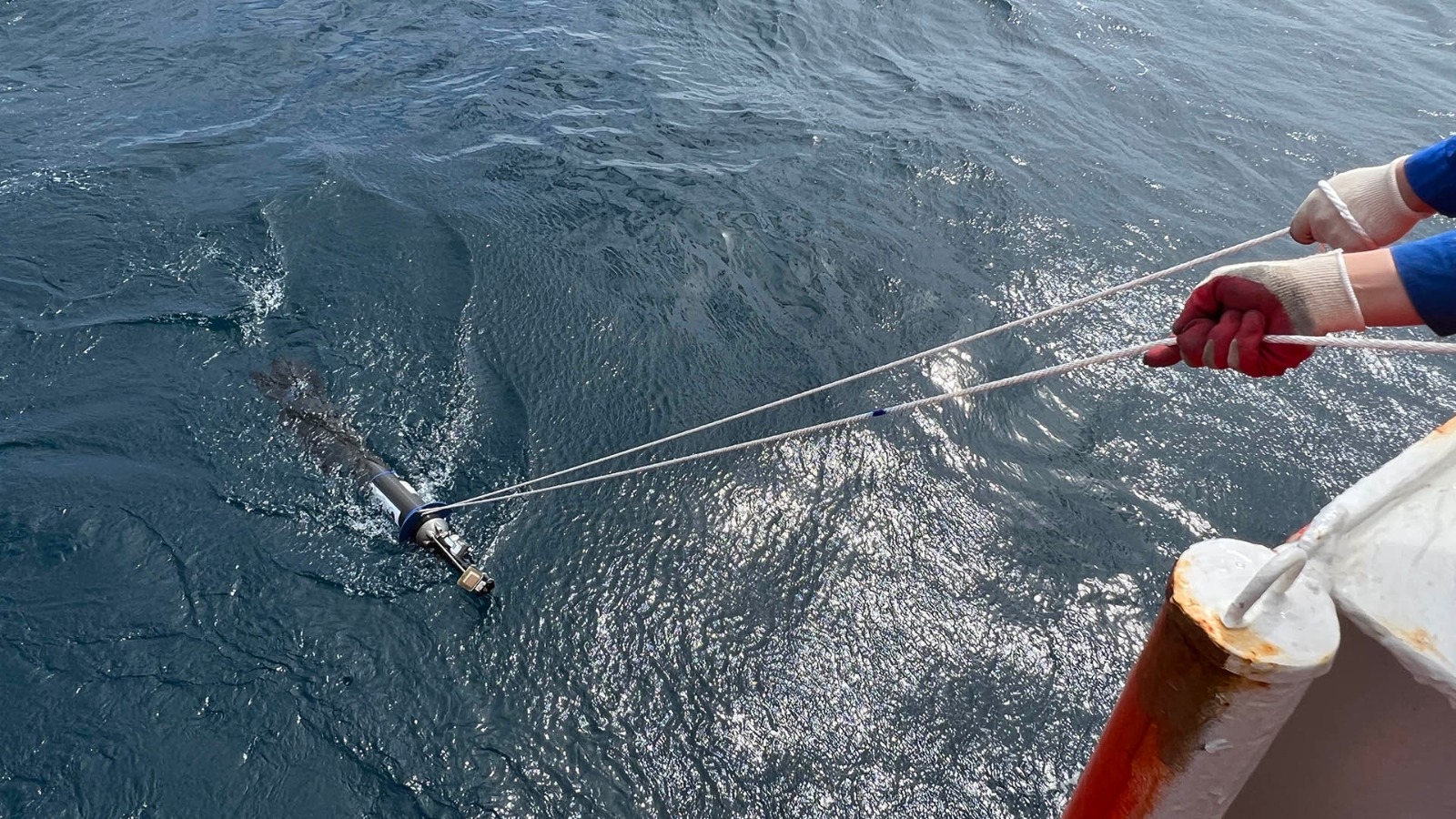 The float Adventure in the wake of the ship as it is being deployed