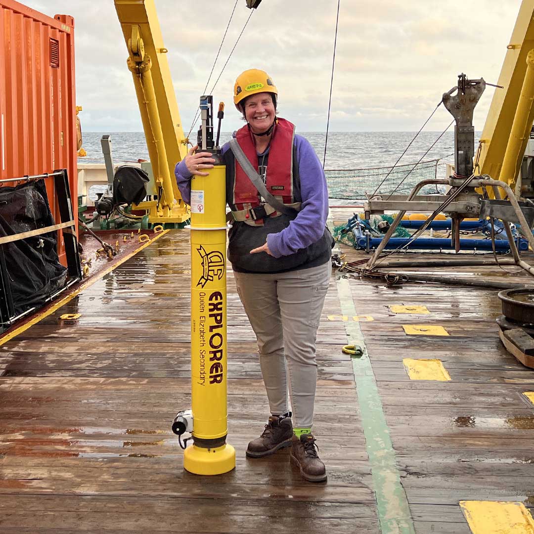 photo of Jenn Magnusson holding the QE Explorer on the deck