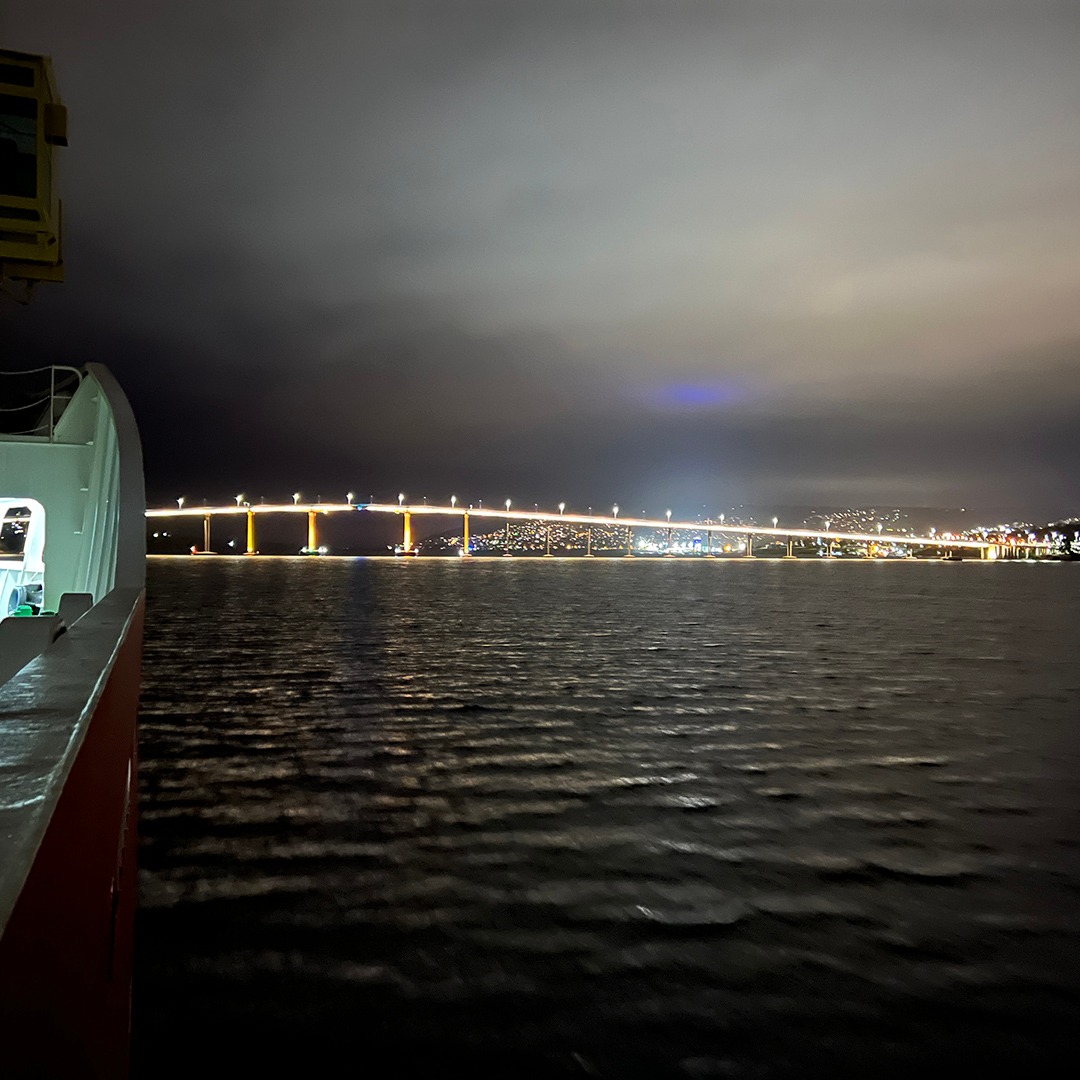 A view of the Tasman Bridge from the deck of the RV Araon, you can see the blue laser from the lighthouse.