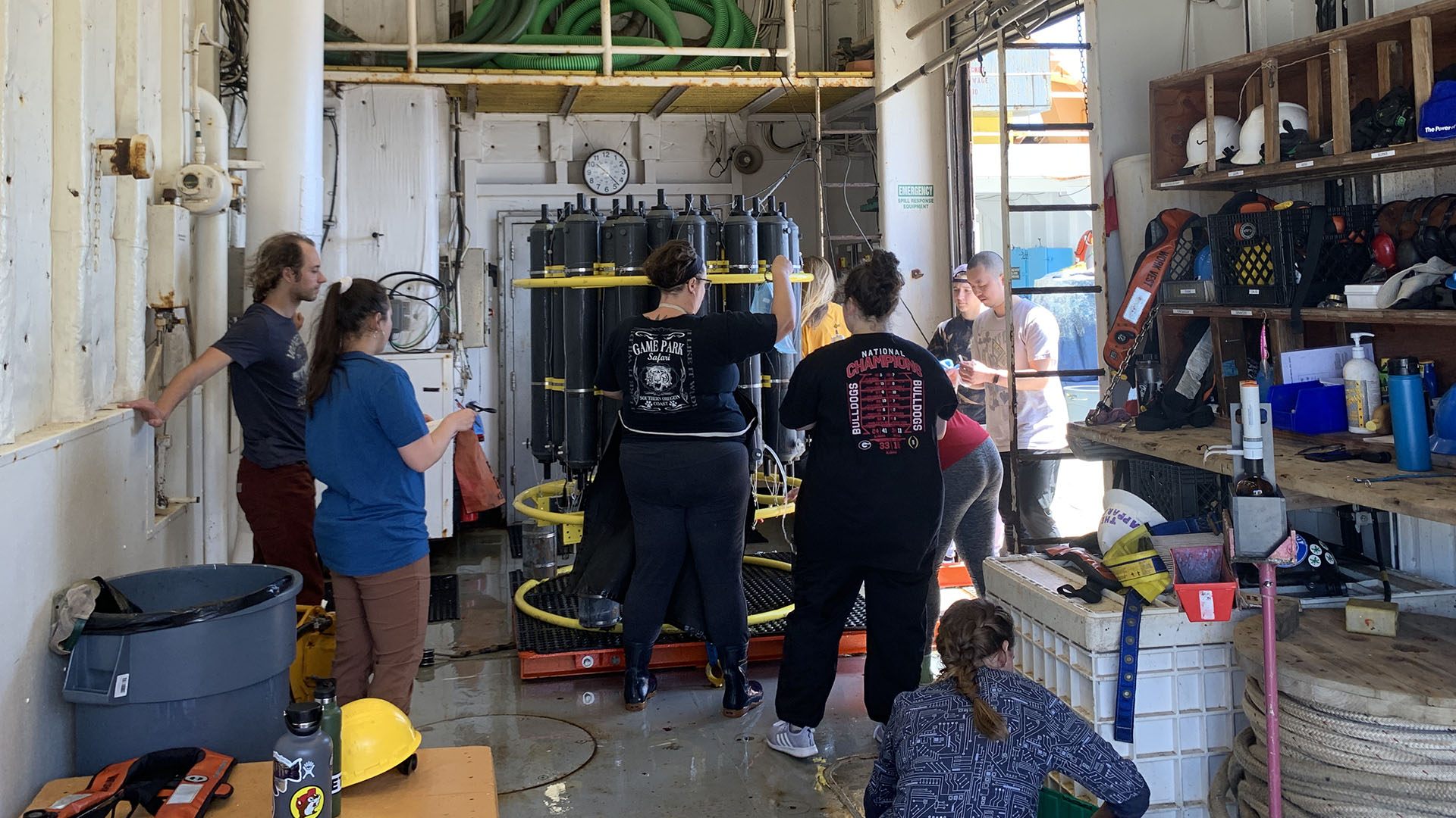 Members of the night shift taking water samples after recovering the CTD (Photo by Ellen Park).