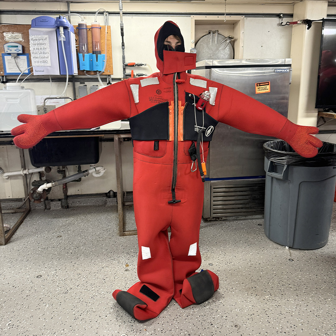 Scientist Daniela Nestory dons her immersion suit during the safety drill.