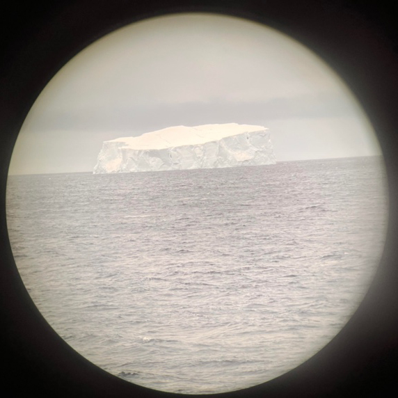 Picture of an iceberg taken with an iPhone through binoculars from the bridge of the R/V Thompson (photo S. Bigorre)