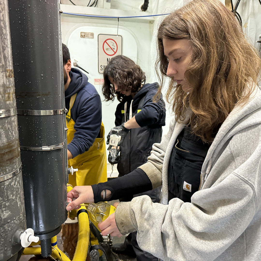 Jess takes a small water sample from each of the Niskin bottles on the rosette